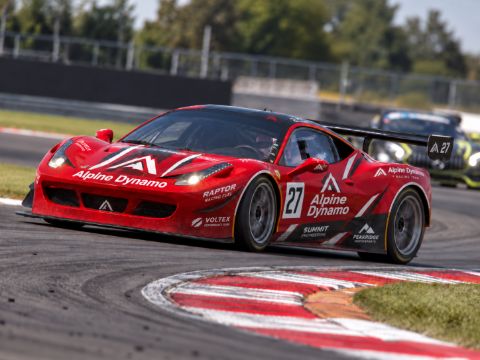 Red race car cornering on a circuit